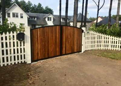 AES (SCOTLAND) LTD new automatic metal framed Iroko clad driveway gates, installed in King's Cairn at Archerfield.