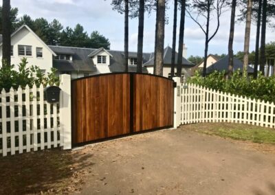 AES (SCOTLAND) LTD new automatic metal framed Iroko clad driveway gates, installed in King's Cairn at Archerfield.