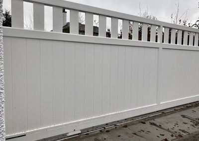 AES (SCOTLAND) LTD newly installed aluminium automatic sliding driveway gate with matching pedestrian gate in RAL9010.