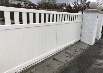 AES (SCOTLAND) LTD newly installed aluminium automatic sliding driveway gate with matching pedestrian gate in RAL9010.