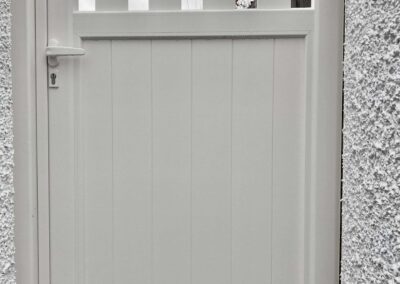 AES (SCOTLAND) LTD newly installed aluminium automatic sliding driveway gate with matching pedestrian gate in RAL9010.