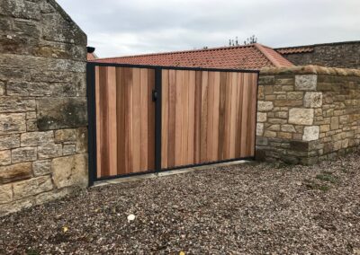 Metal framed cedar infill driveway gate installed in St Andrews Fife