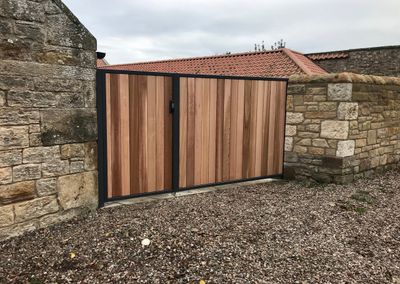 Metal framed cedar infill driveway gate installed in St Andrews Fife