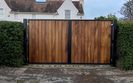 AES (SCOTLAND) LTD recently installed automatic metal framed Iroko infill driveway gates in Edinburgh