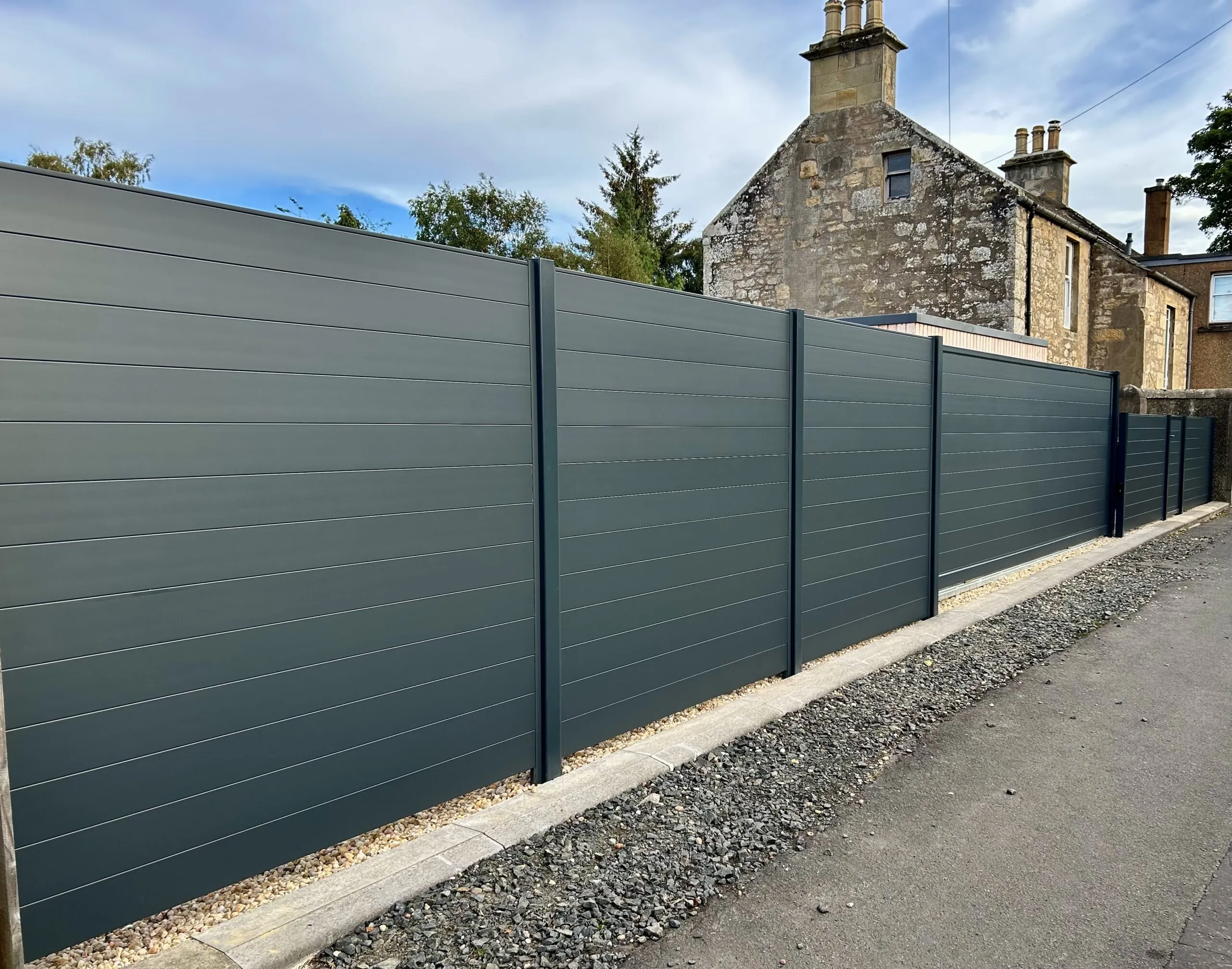 Electric aluminium tracked sliding gate with matching fencing panels installed in Fife