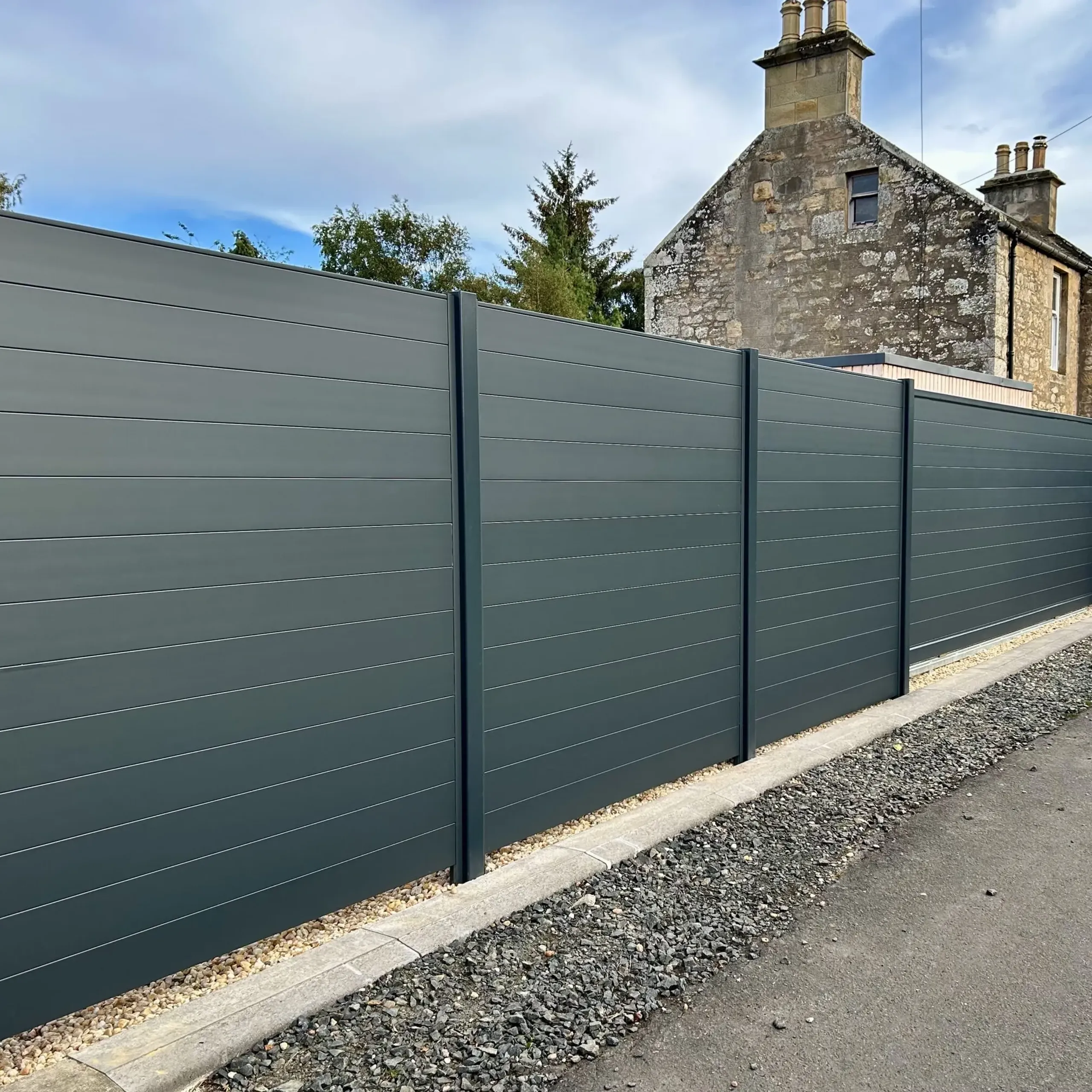 Electric aluminium tracked sliding gate with matching fencing panels installed in Fife