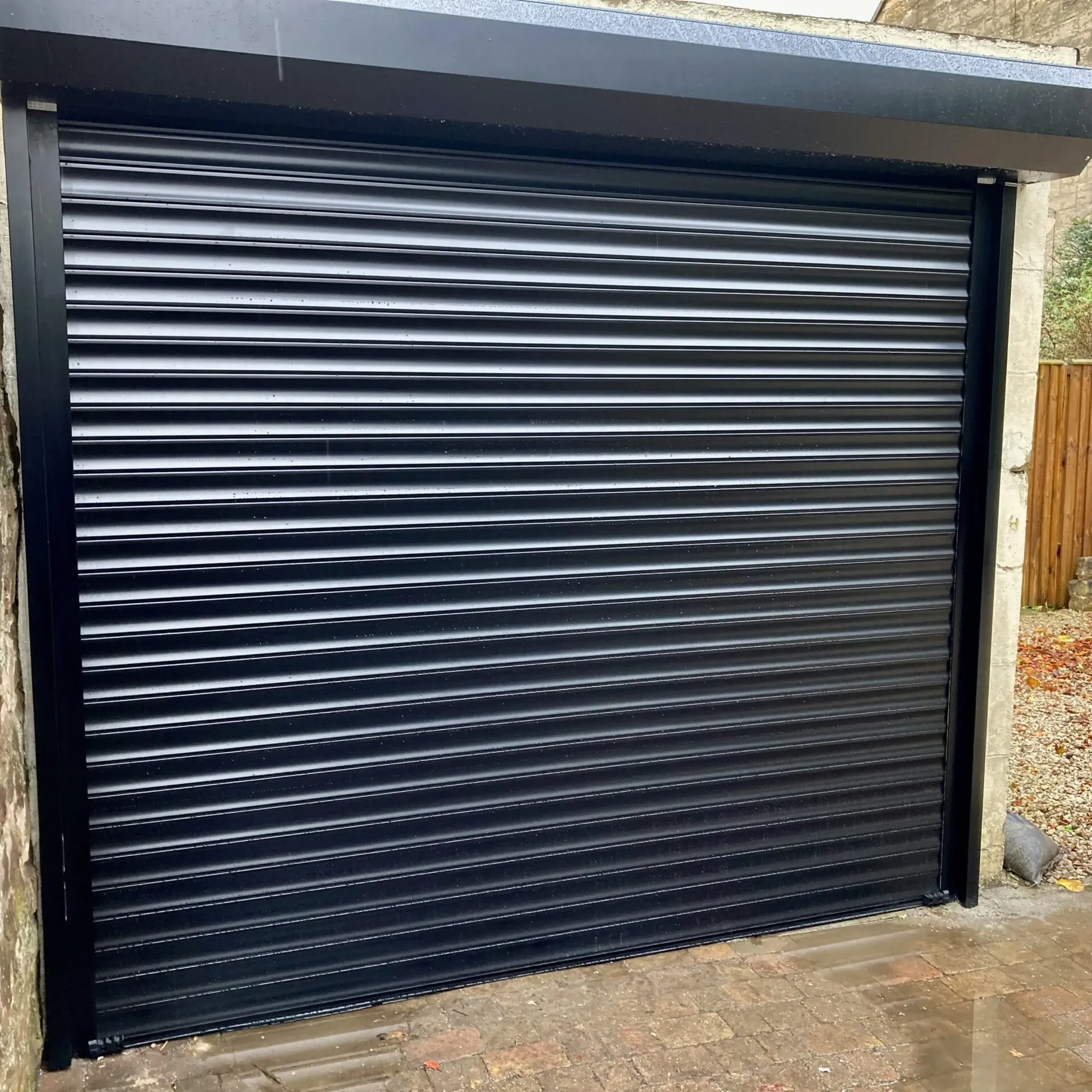 Black automatic insulated roller garage door installed in Edinburgh