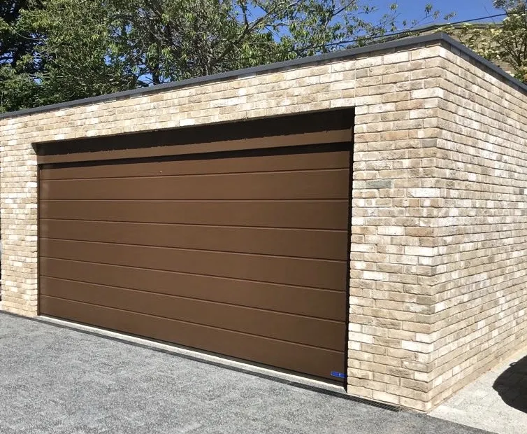 Brown automatic sectional garage door installed at a residential development in Edinburgh