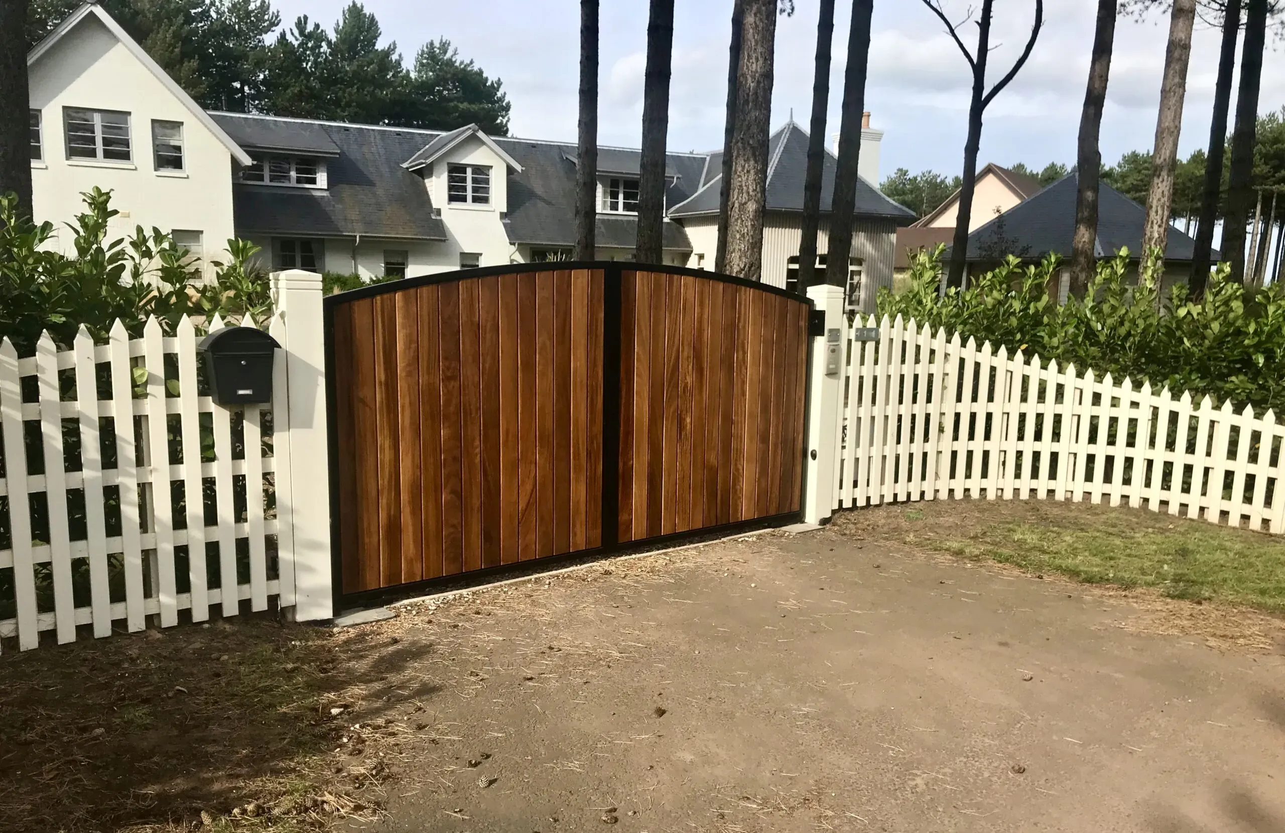 Automatic metal framed gates clad with stained iroko timber installed in Edinburgh 