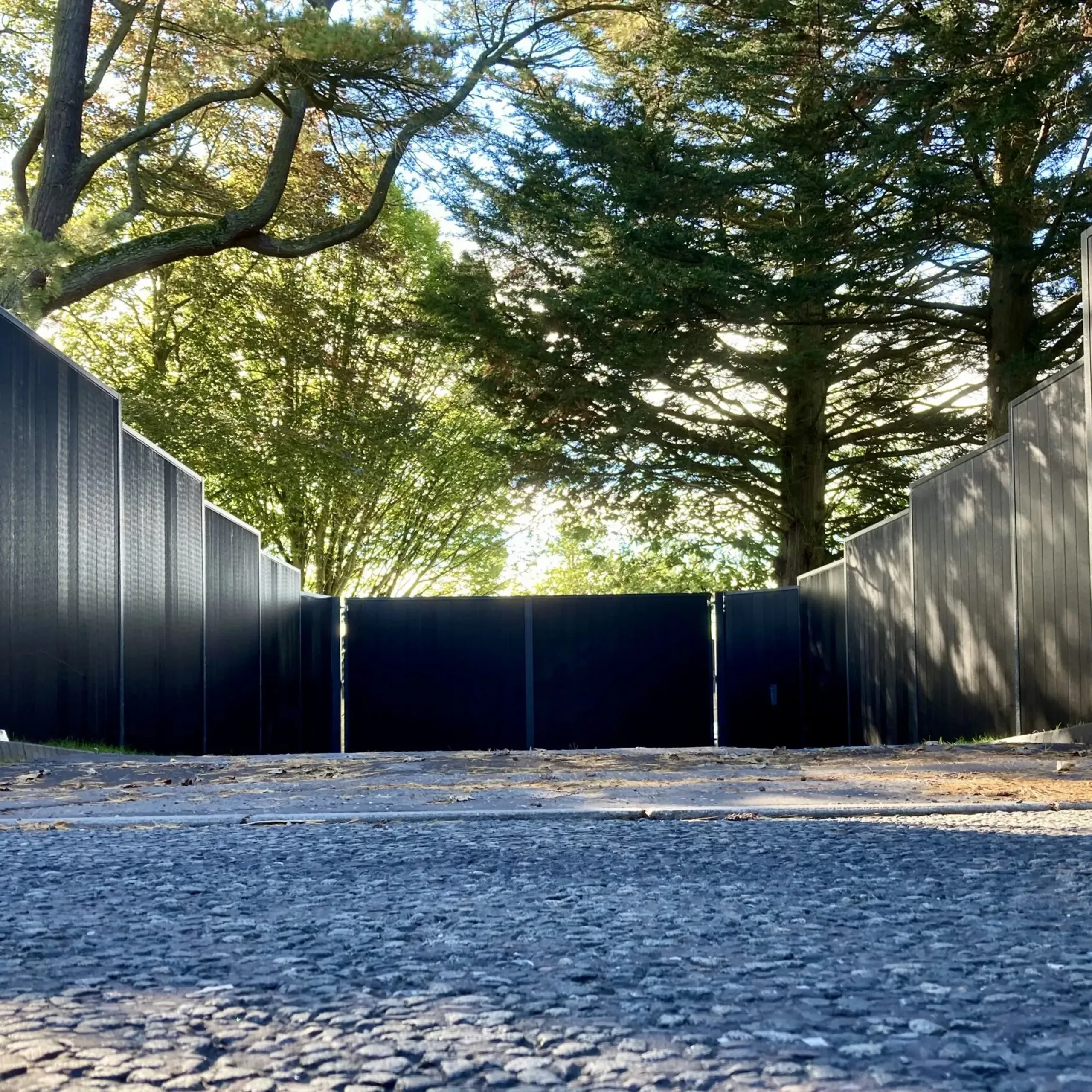 A pair of black electric composite gates with matching fencing panels installed in Perth 