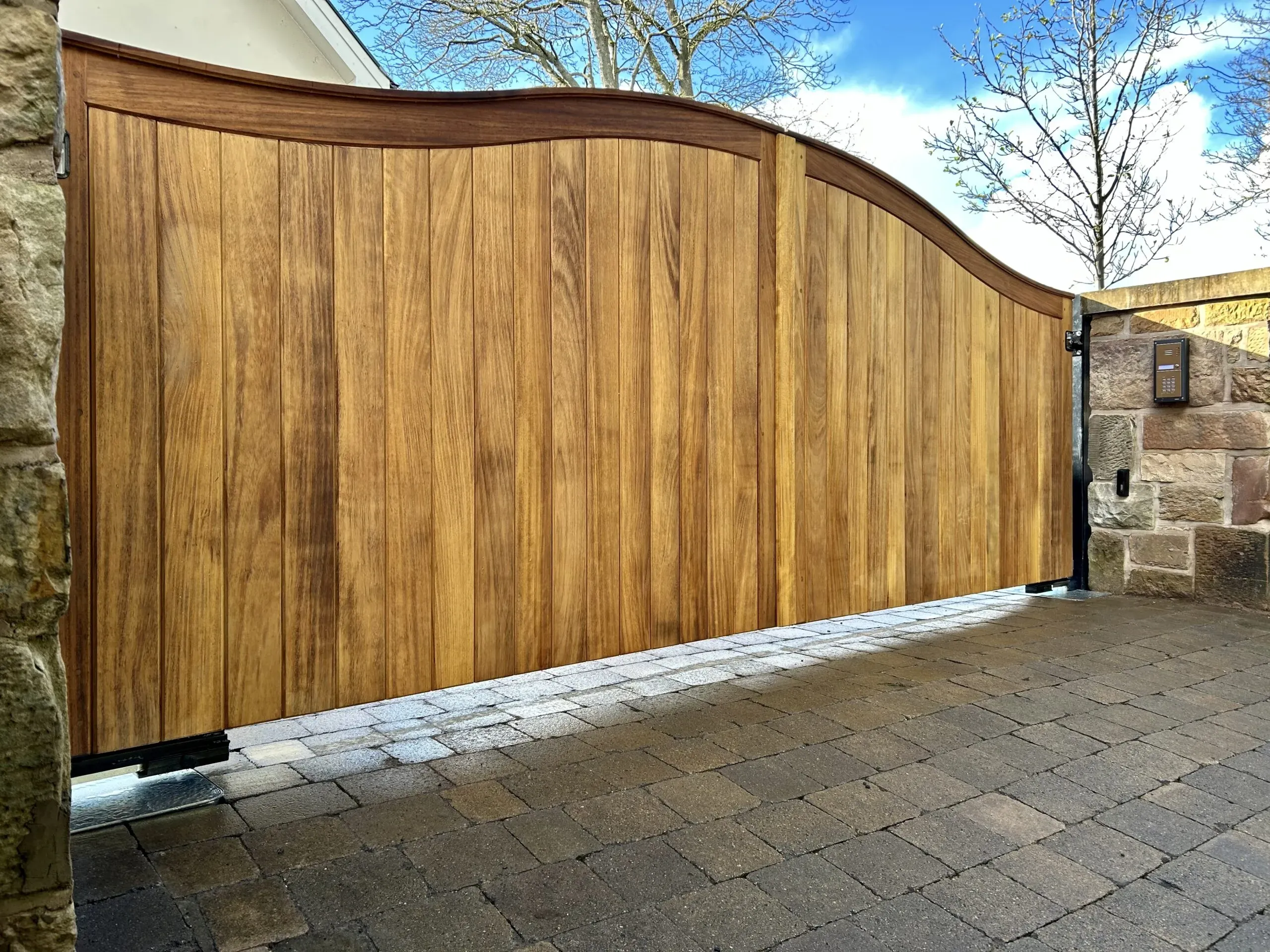 Solid handcrafted timber electric gates with underground operators in Scotland 