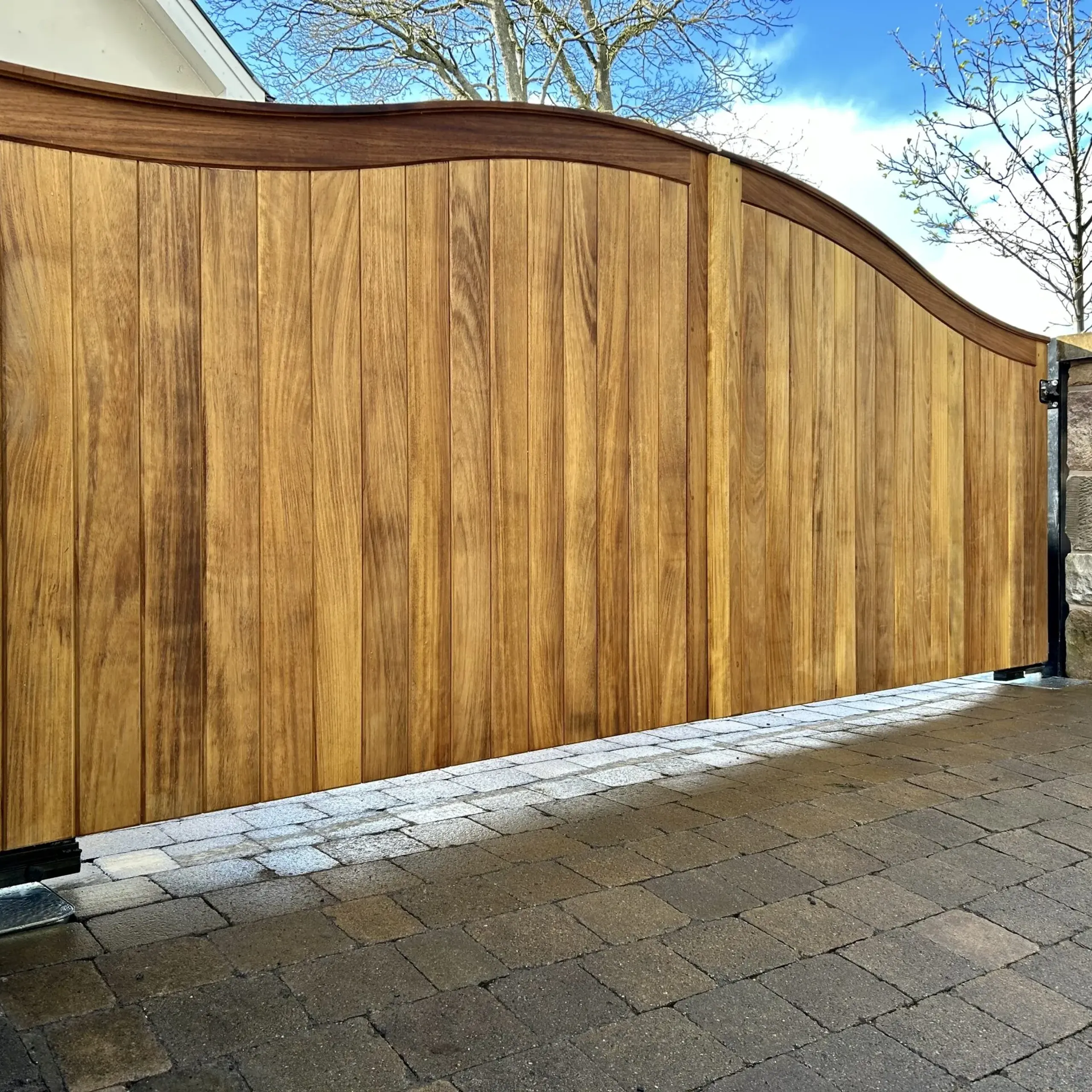 Solid handcrafted timber electric gates with underground operators in Scotland 