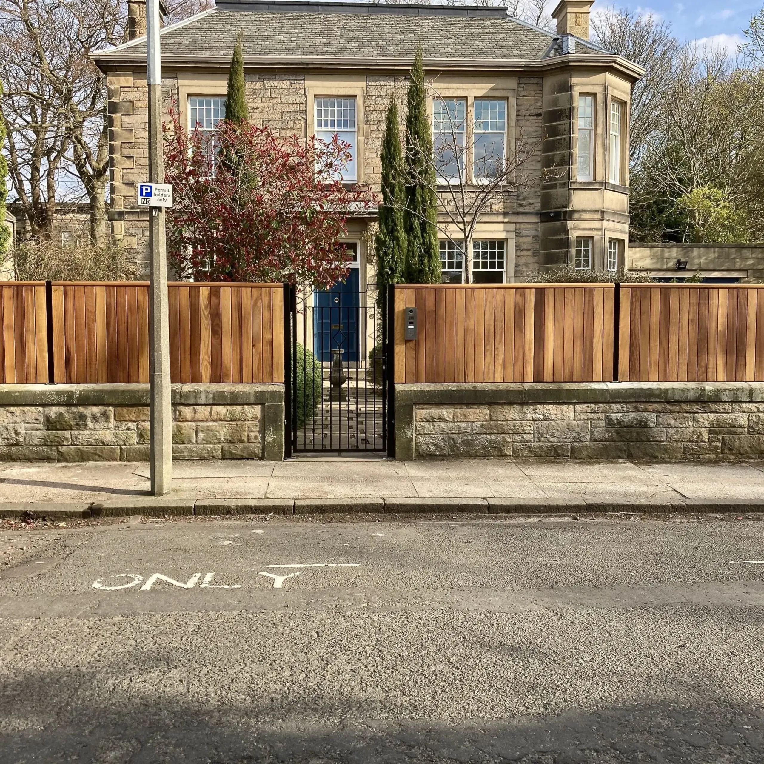 Solid Iroko hardwood wall top fencing panels installed in Edinburgh 
