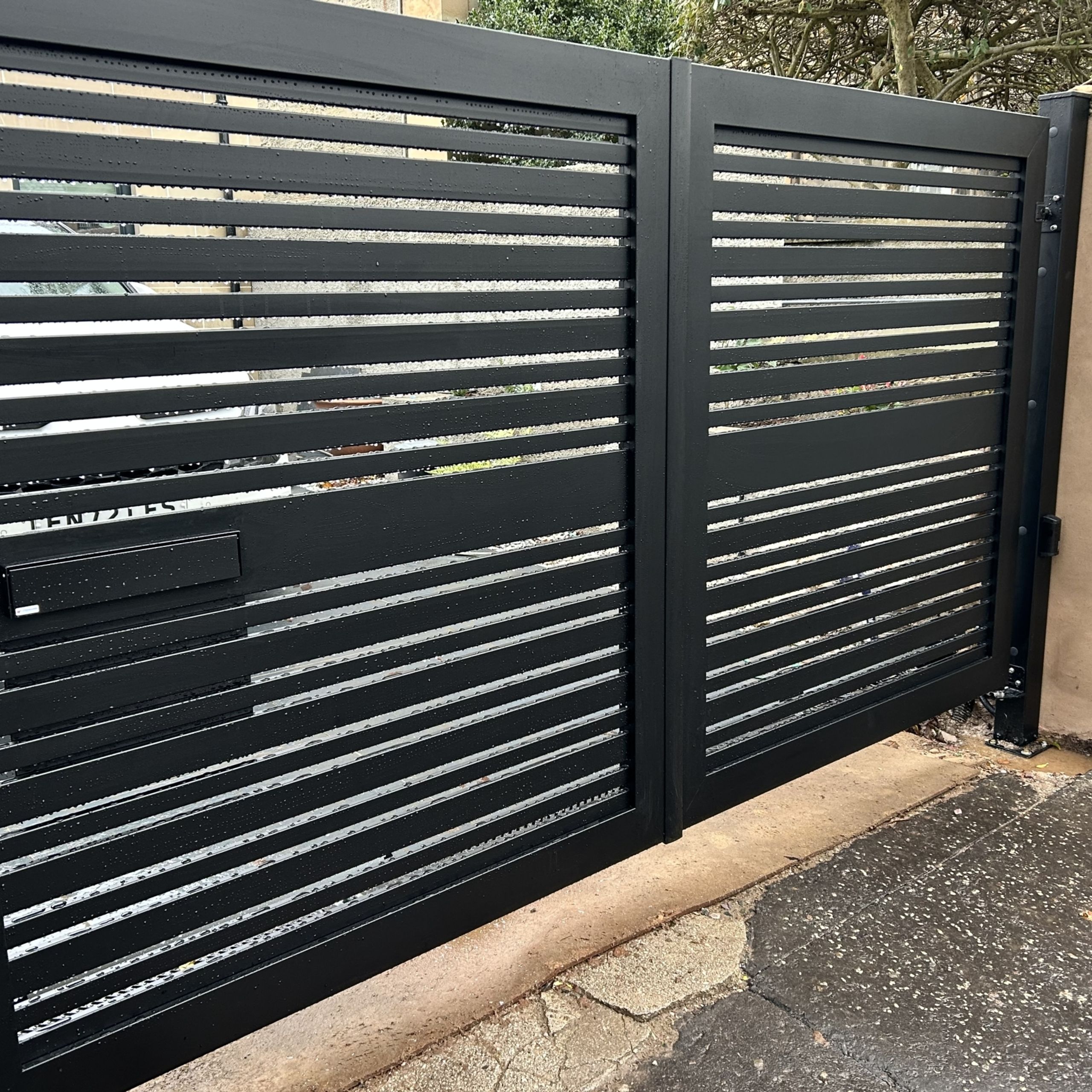 Electric aluminium black slatted driveway gates installed in Edinburgh.